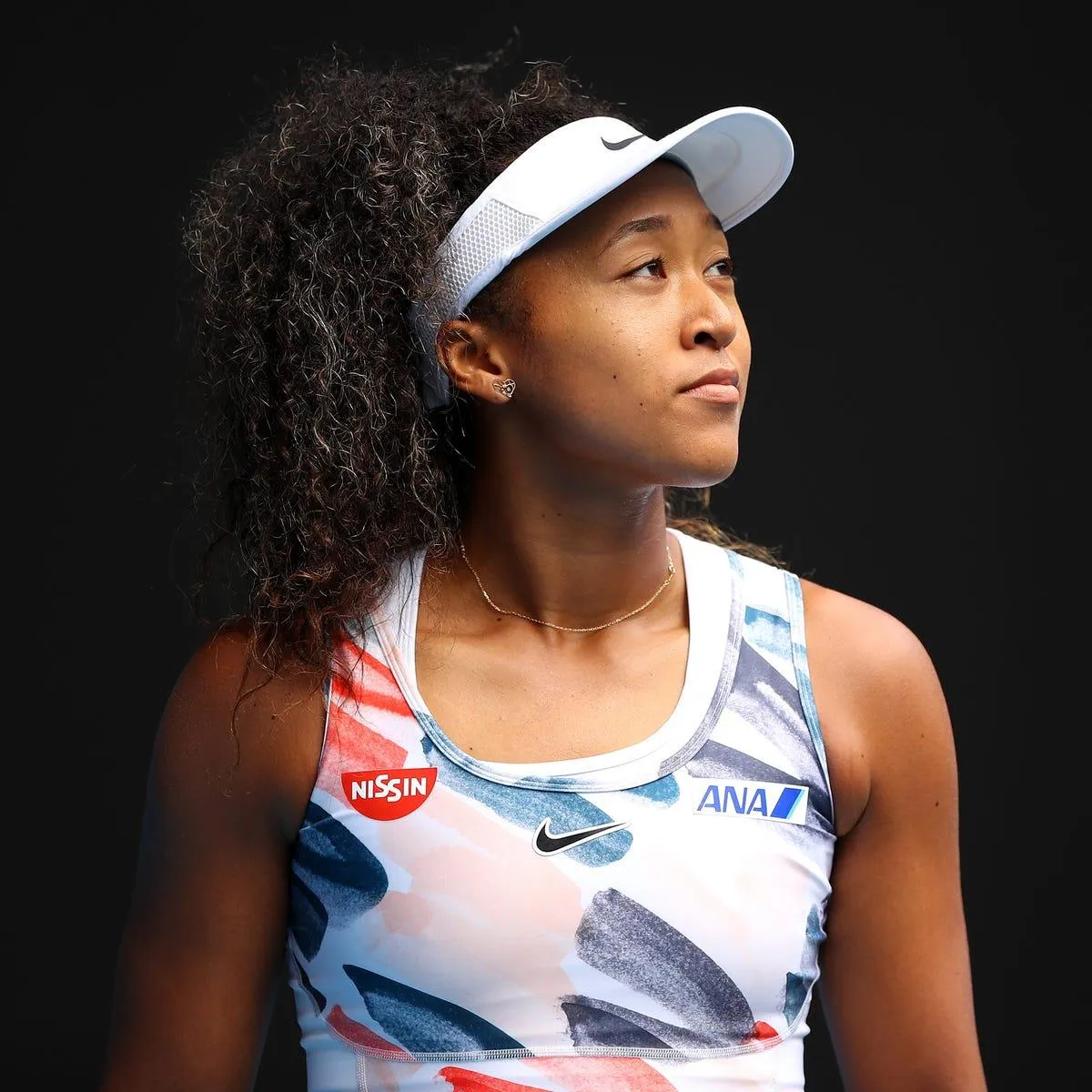 Naomi Osaka during a professional tennis appearance, known for her powerful game and four Grand Slam titles.