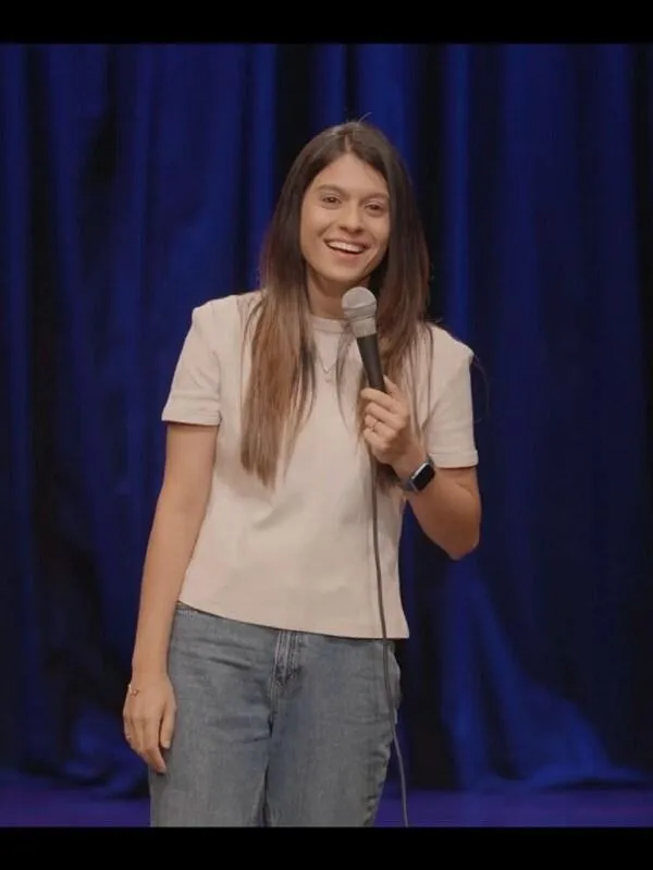 Shashi Dhiman performing during a stand-up comedy show.
